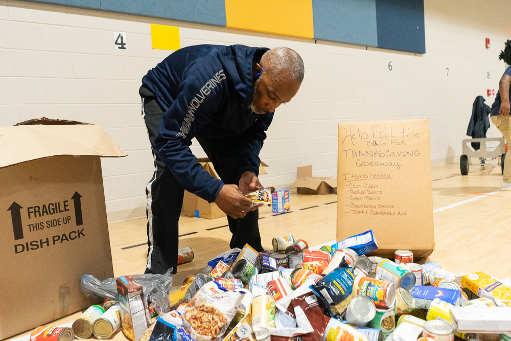 Lane Harper goes through donations at I3 Academy in Woodlawn ahead of distribution. (Marika N. Johnson, For The Birmingham Times)