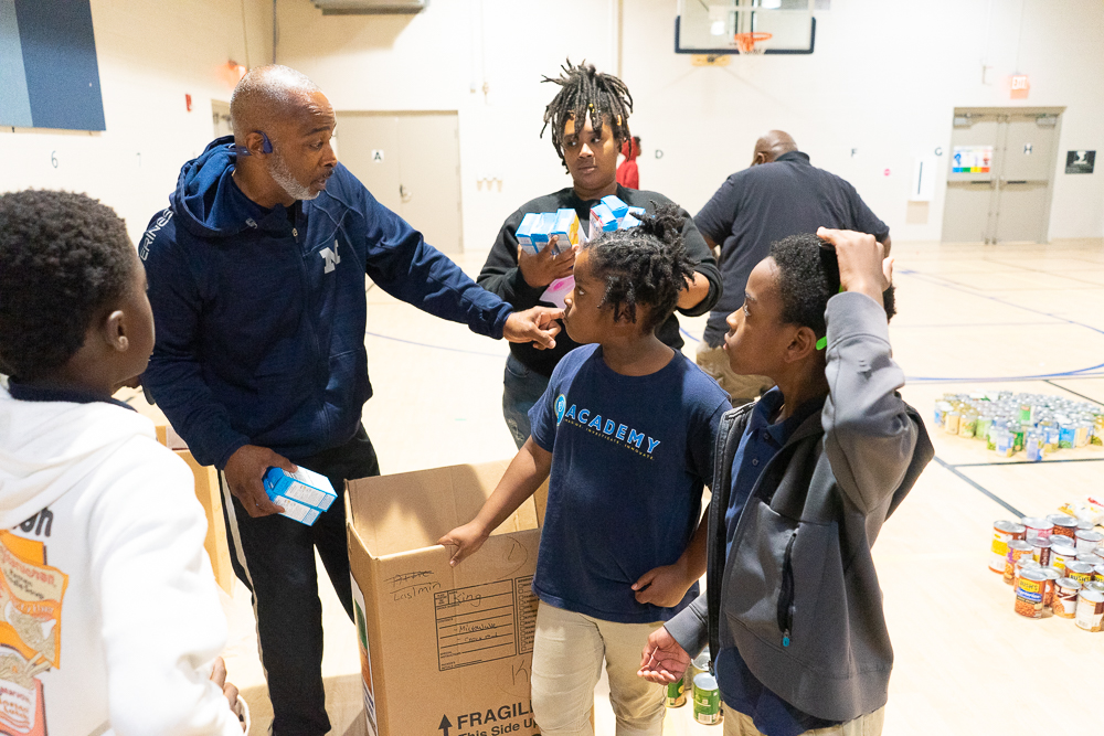 Lane Harper provides instructions for volunteers at I3Academy ahead of a food giveaway in Fultondale, Alabama. (Marika N. Johnson, For The Birmingham Times)
