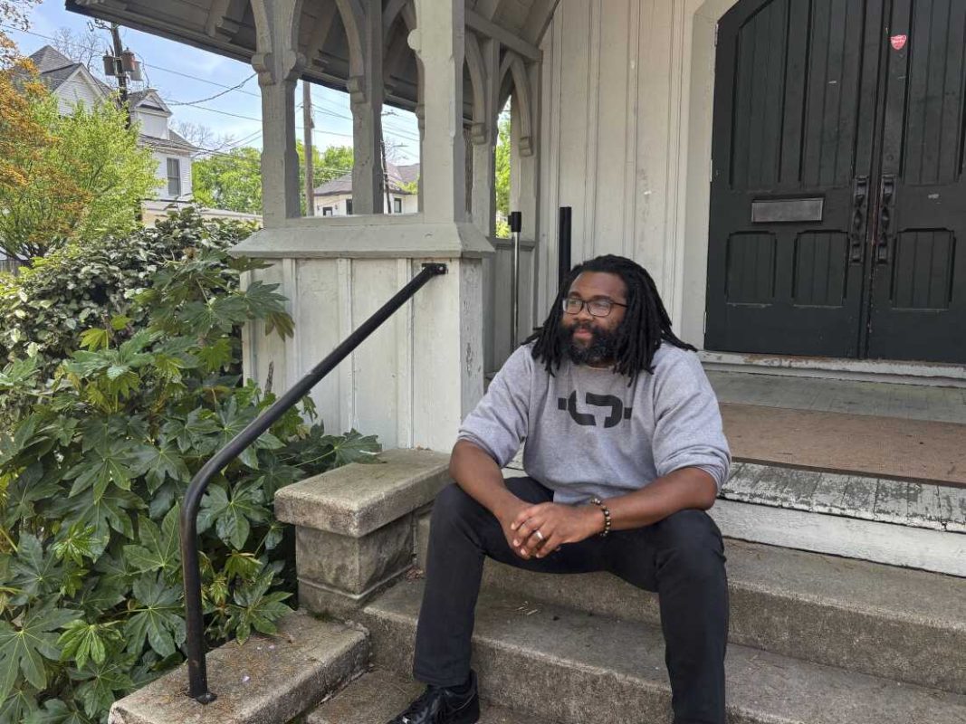 Evan Milligan, the named plaintiff in the redistricting lawsuit, sits the porch of a community center he runs in a former church in Montgomery.