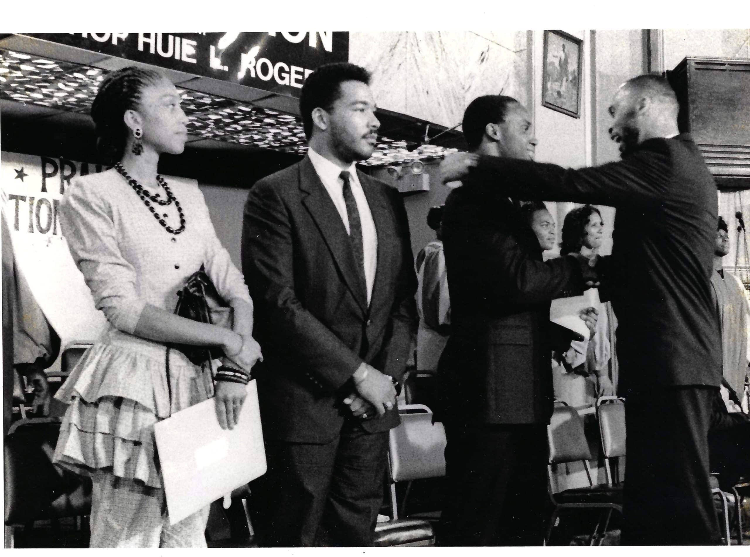 Countdown 88 Director, Selwyn Carter, on stage at the Greater Bibleway Temple in Brooklyn, New York, greeting JJonathan Jackson, Dexter King, and Attallah Shabazz — the children of Jesse Jackson, Martin Luther King Jr., and Malcolm X — in a powerful show of generational unity.